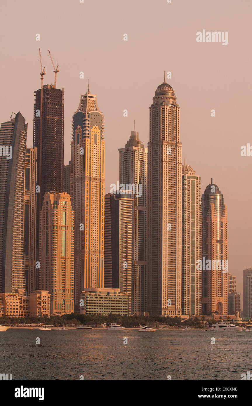 Un tramonto skyline cityscape di edifici torri intorno alla Marina di Dubai, Dubai, Emirati arabi uniti (EAU). Foto Stock