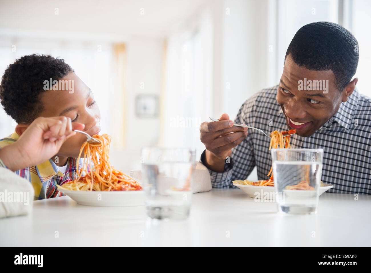 Padre e figlio di mangiare insieme a tavola Foto Stock