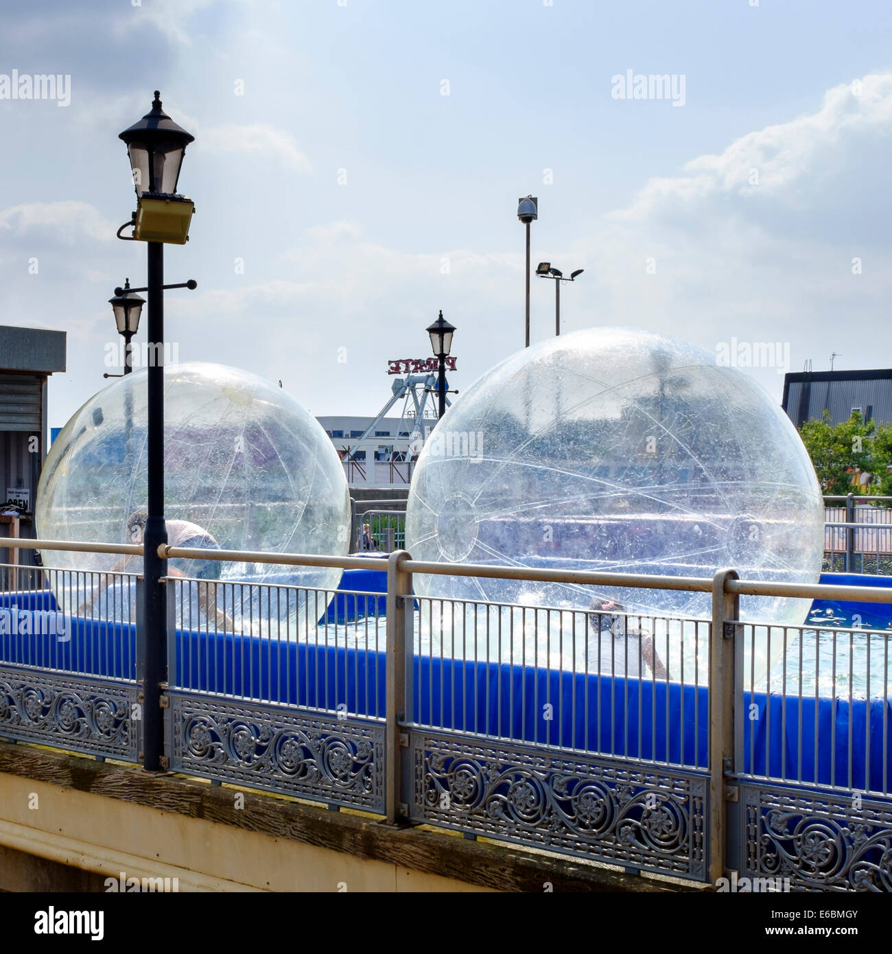Skegness, Lincolnshire, Inghilterra. I bambini giocano in zorb sfere godendo la pratica nota come zorbing. 30Luglio 2014. Foto Stock
