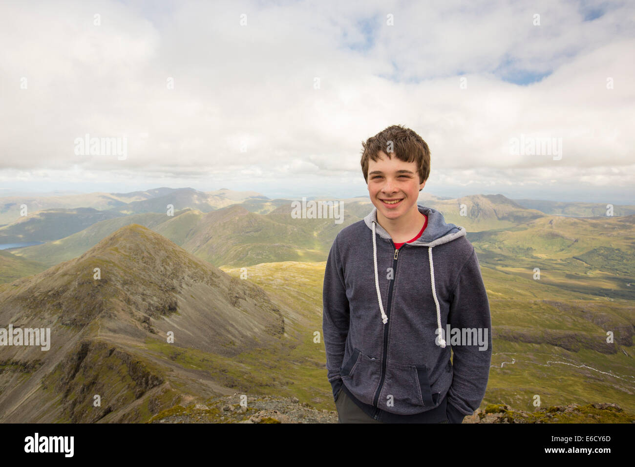 Un ragazzo adolescente sul vertice di Ben più, un Munro sull'Isle of Mull, Scotland, Regno Unito. Foto Stock