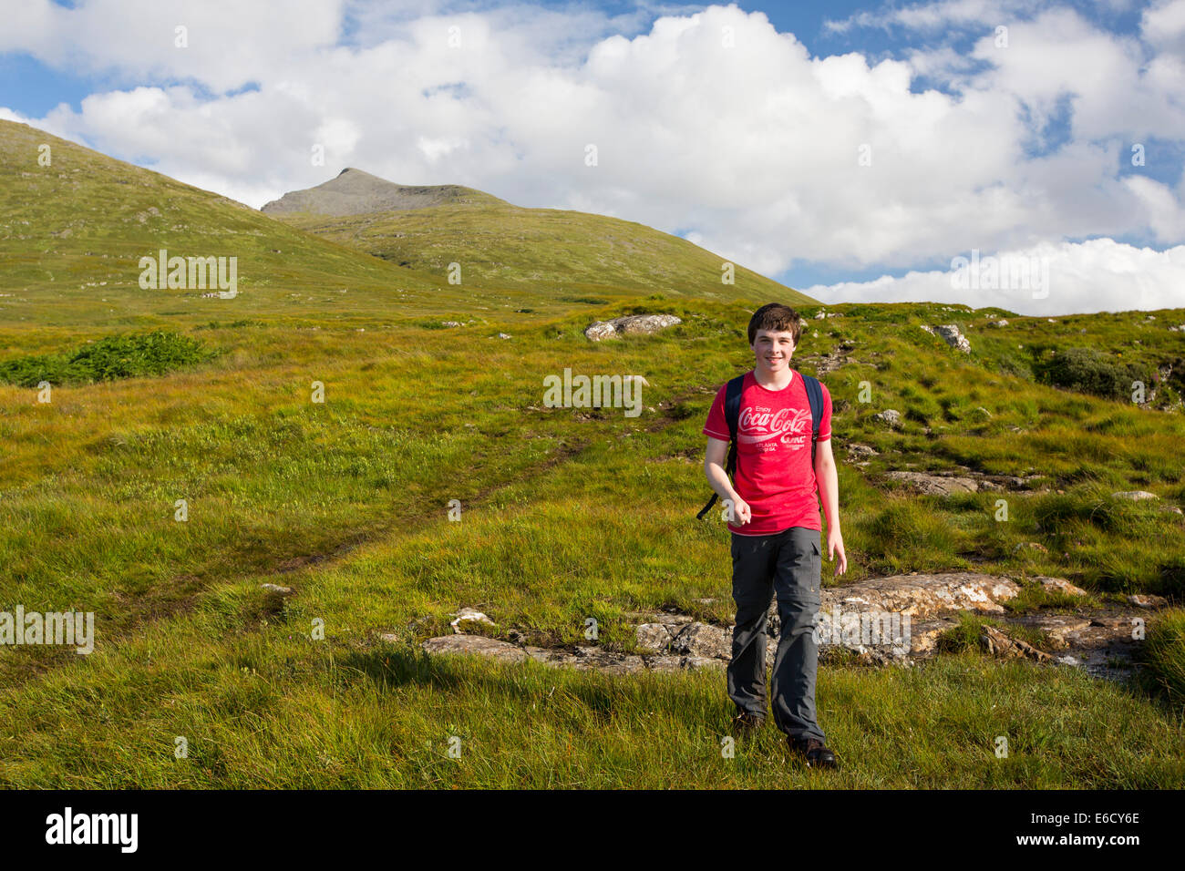 Un ragazzo adolescente salendo ben di più, un Munro sull'Isle of Mull, Scotland, Regno Unito. Foto Stock