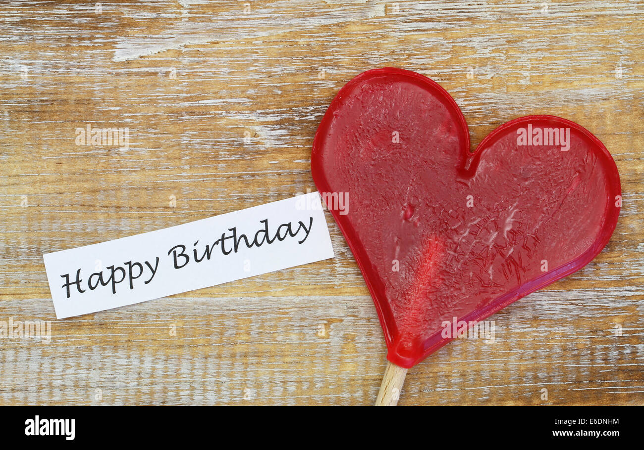 Buon compleanno con carta a forma di cuore ad lecca-lecca Foto Stock