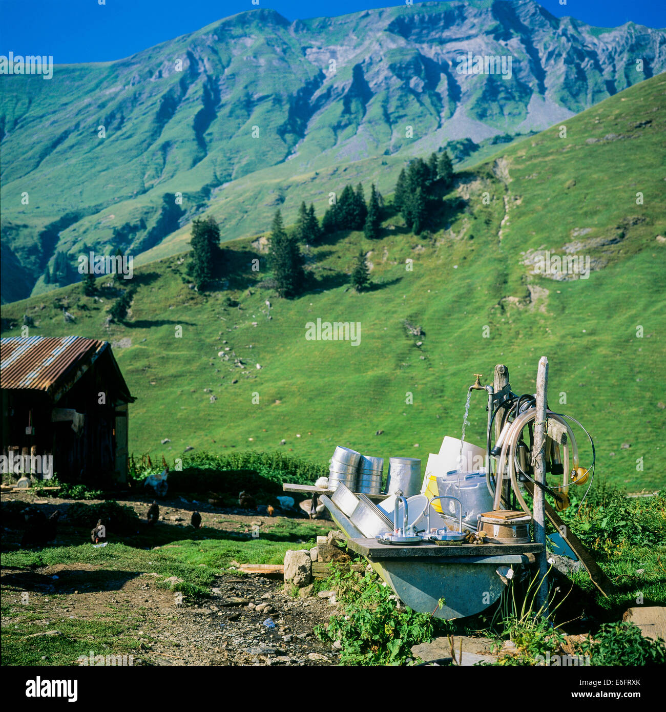 Le attrezzature per la mungitura viene lavato in una vasca esterna Morzine Savoy sulle Alpi francesi Francia Foto Stock