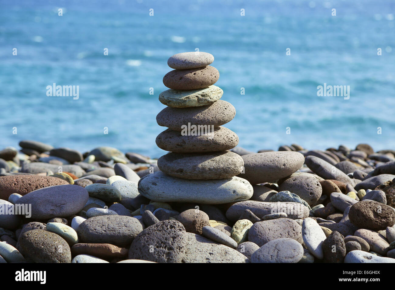 Pyramid dai sassolini contro il mare Foto Stock