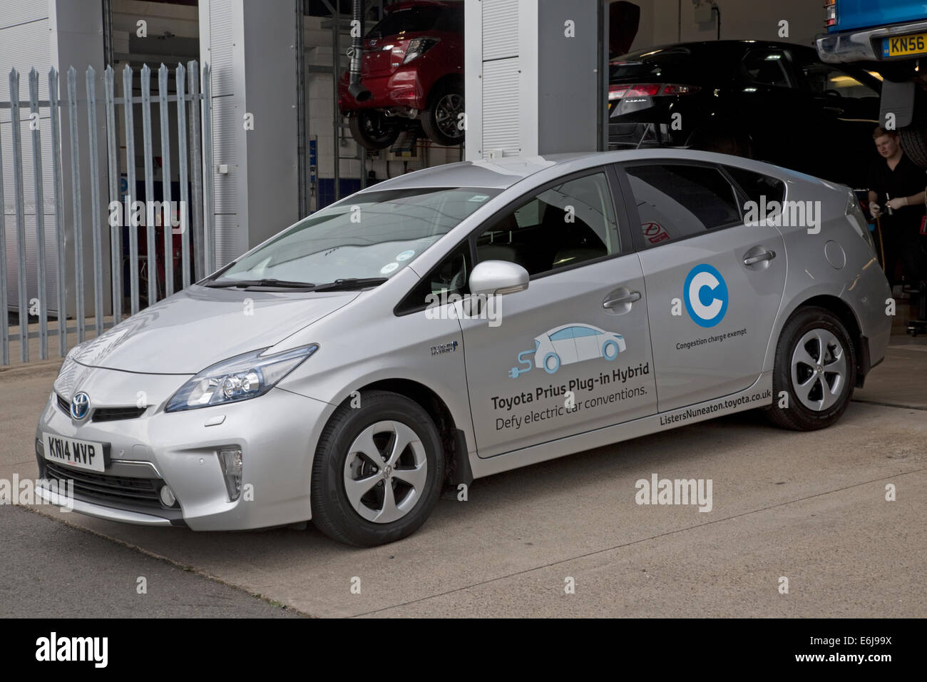 La Toyota Prius Plug In OLEV ultra bassa emissione di dimensioni medie e plug-in veicolo elettrico ibrido parcheggiata fuori Lister's Garage Foto Stock