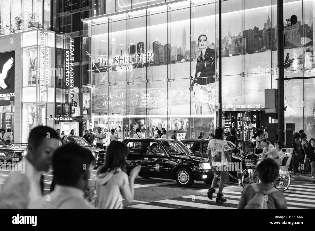 Le riflessioni di insegne in una serata calda nella finestra dello shelter in Omotesando, Tokyo. Foto Stock