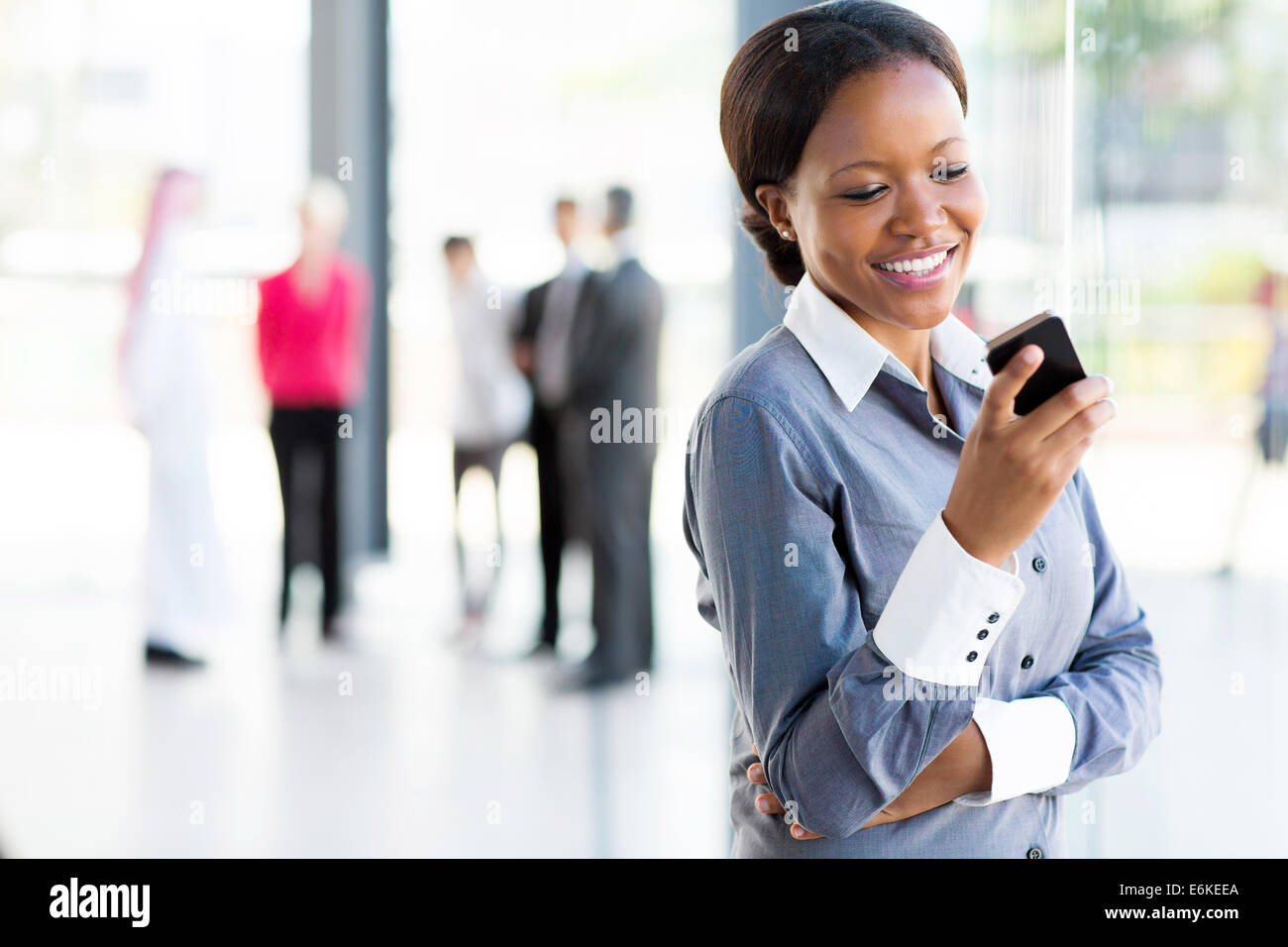 Felice americano africano donna di carriera tramite telefono cellulare Foto Stock