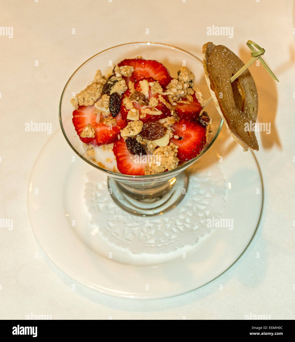 Yogurt con fragole, mirtilli e dadi, guarnita con tutto il grano bagel chip. Foto Stock