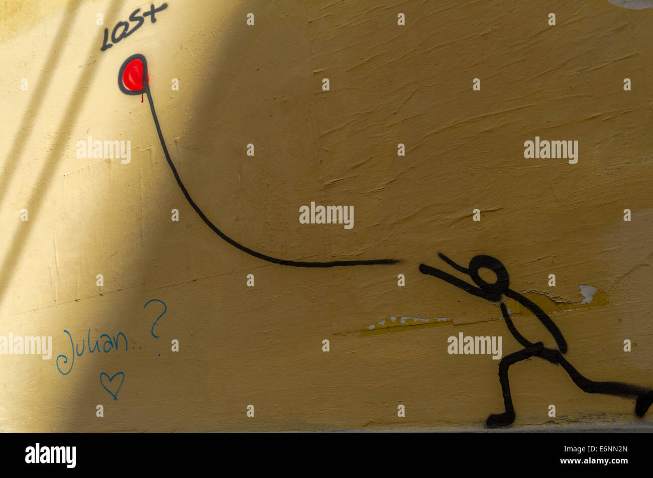 Disegno di un bastone uomo cerca di catturare un rosso perso il palloncino. Foto Stock