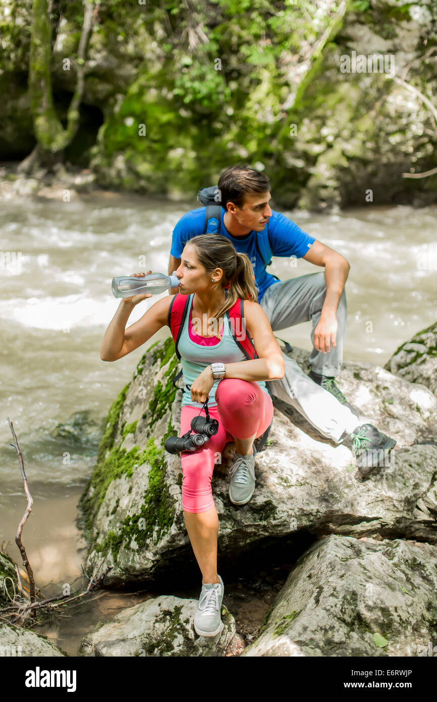 Giovane donna trekking nella foresta Foto Stock