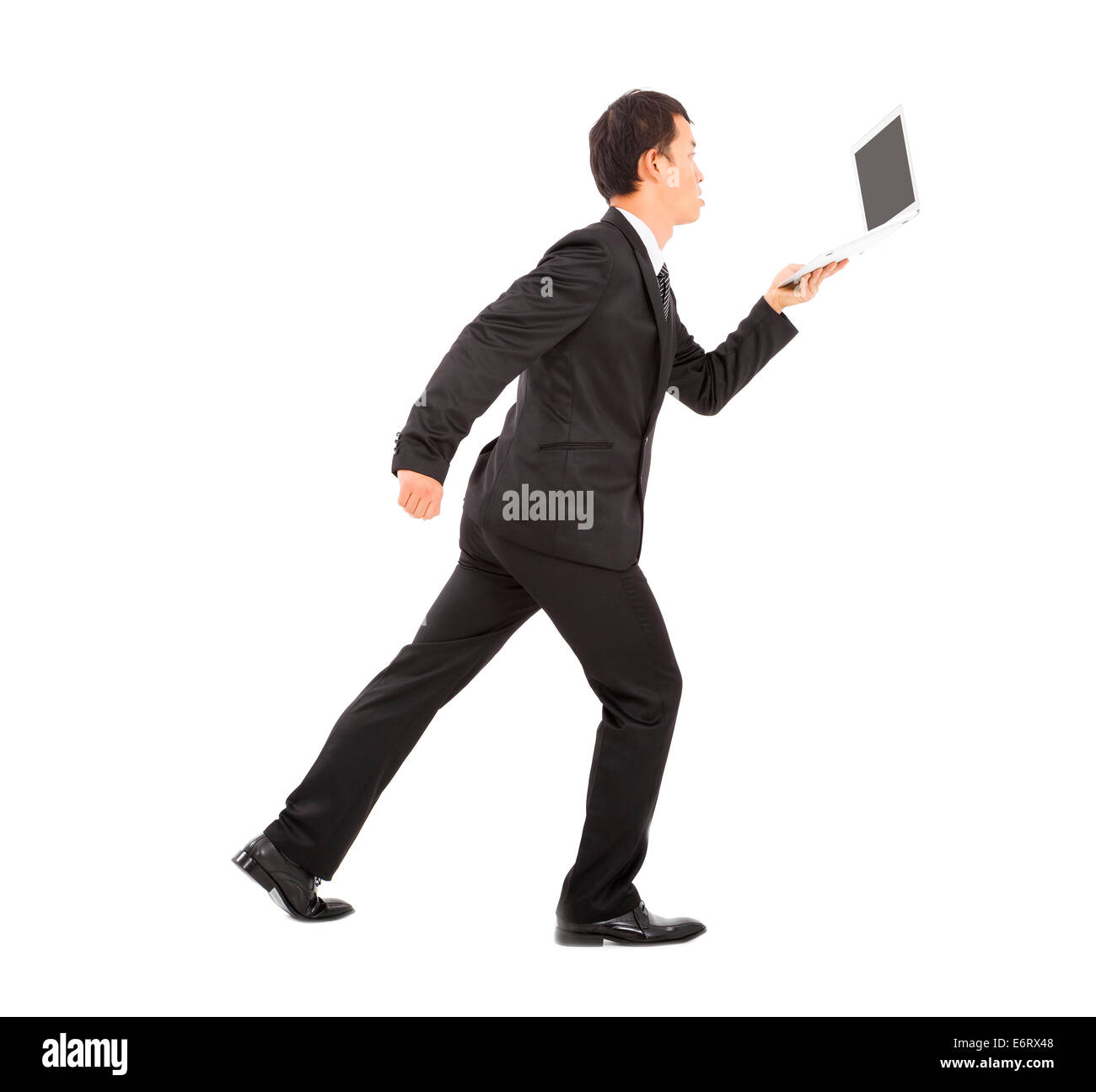 Imprenditore positiva esecuzione alacremente e in possesso di un computer portatile Foto Stock