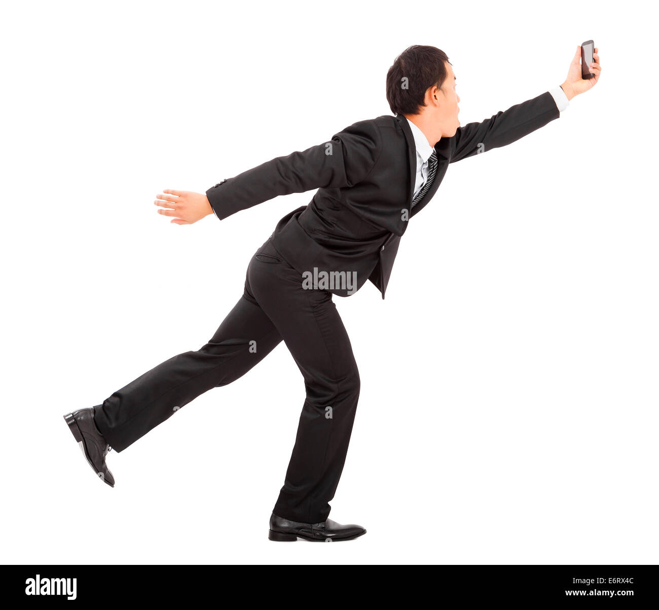 Imprenditore in esecuzione alacremente e in possesso di una smart phone Foto Stock