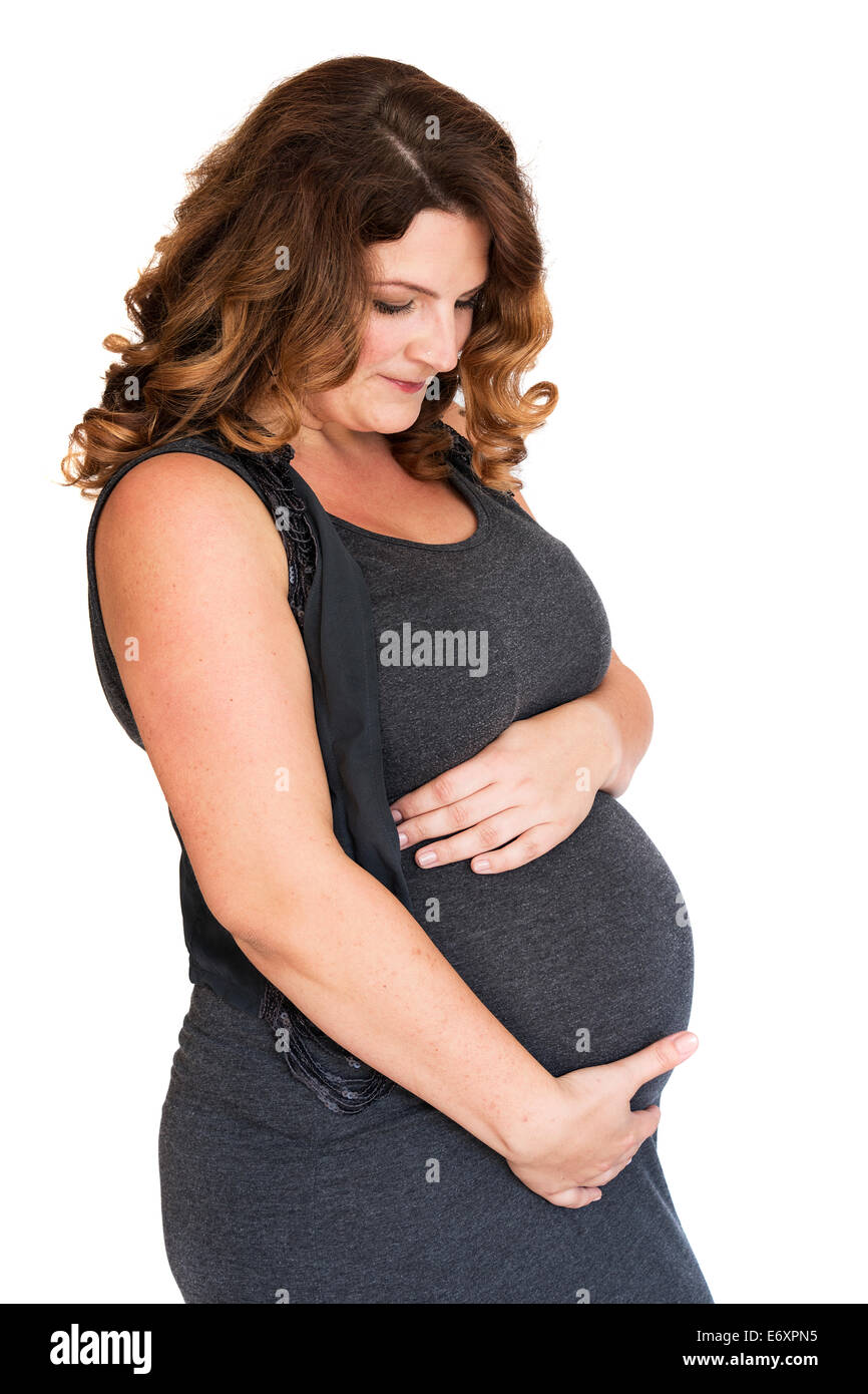 Donna incinta tenendo le sue mani sul suo ventre Foto Stock
