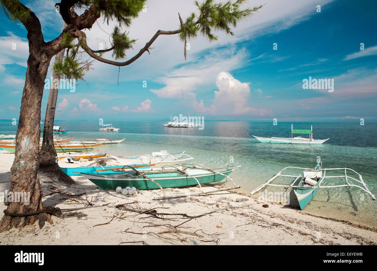 Outrigger barche da pesca sulla sabbia bianca spiaggia tropicale a Malapascua Island, Filippine Foto Stock