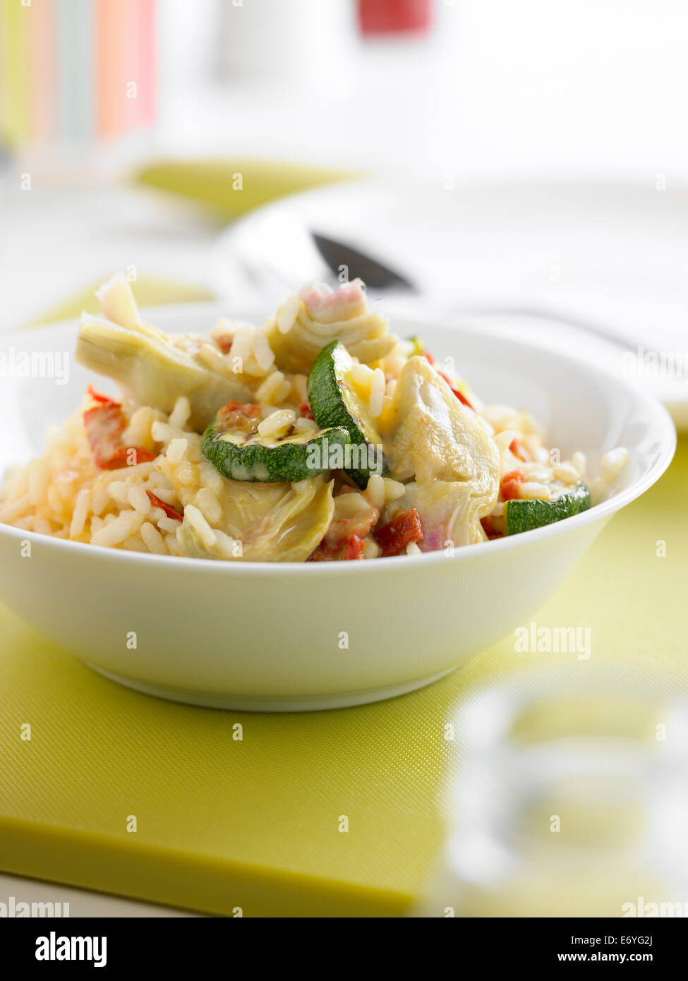 Risotto con carciofi, zucchine e pomodori secchi Foto Stock