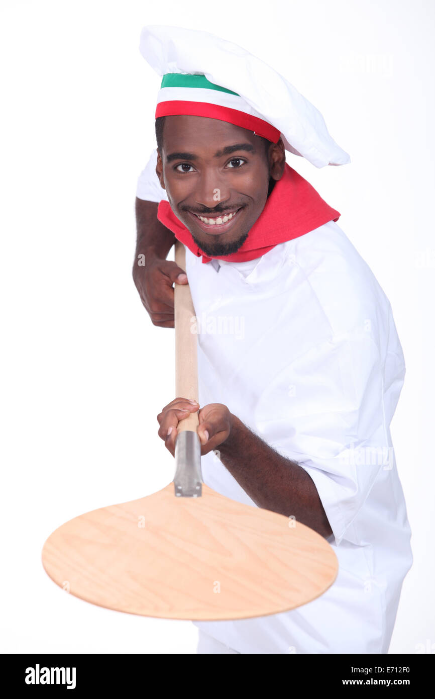 Cuocere la pizza con la pala Foto Stock