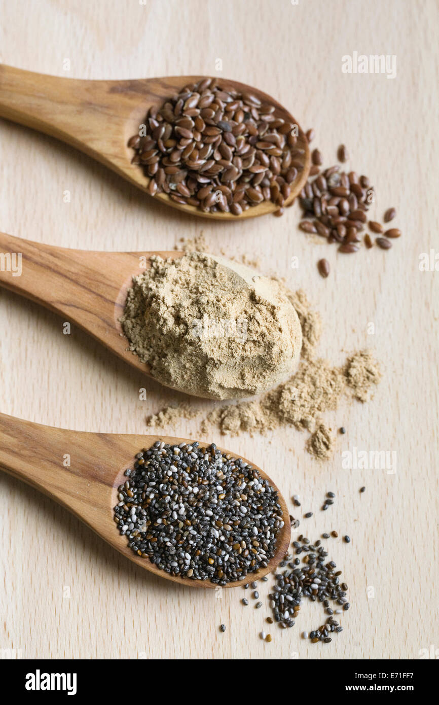 Semi di Chia, polvere di maca e i semi di lino su cucchiai di legno. Foto Stock