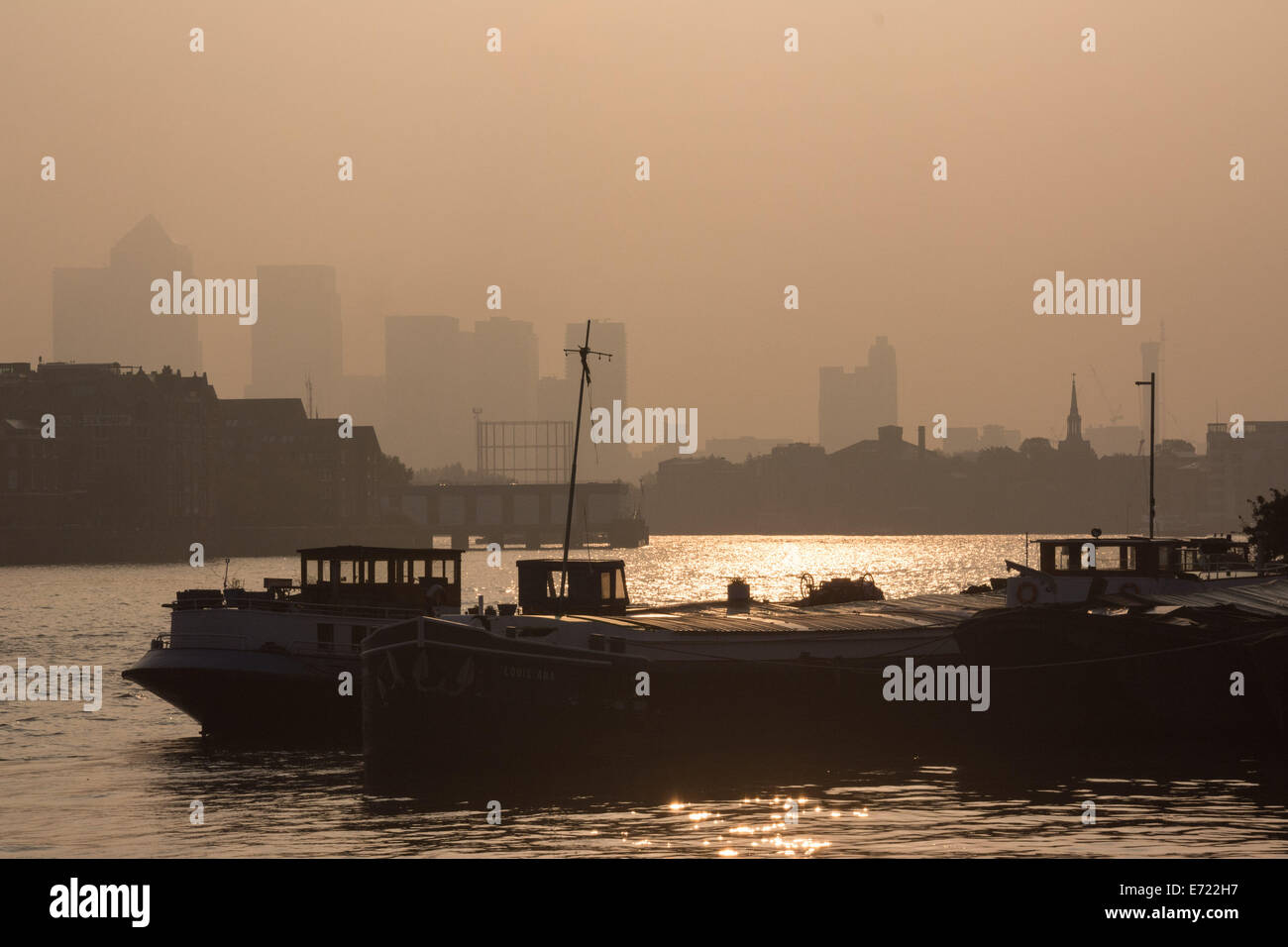 Londra, UK, 4 settembre 2014. Navi e imbarcazioni ormeggiate nel Tamigi si stagliano contro il cielo d'oro come scie di Londra per una bella mattina nebbiosa. Credito: Patricia Phillips/Alamy Live News Foto Stock