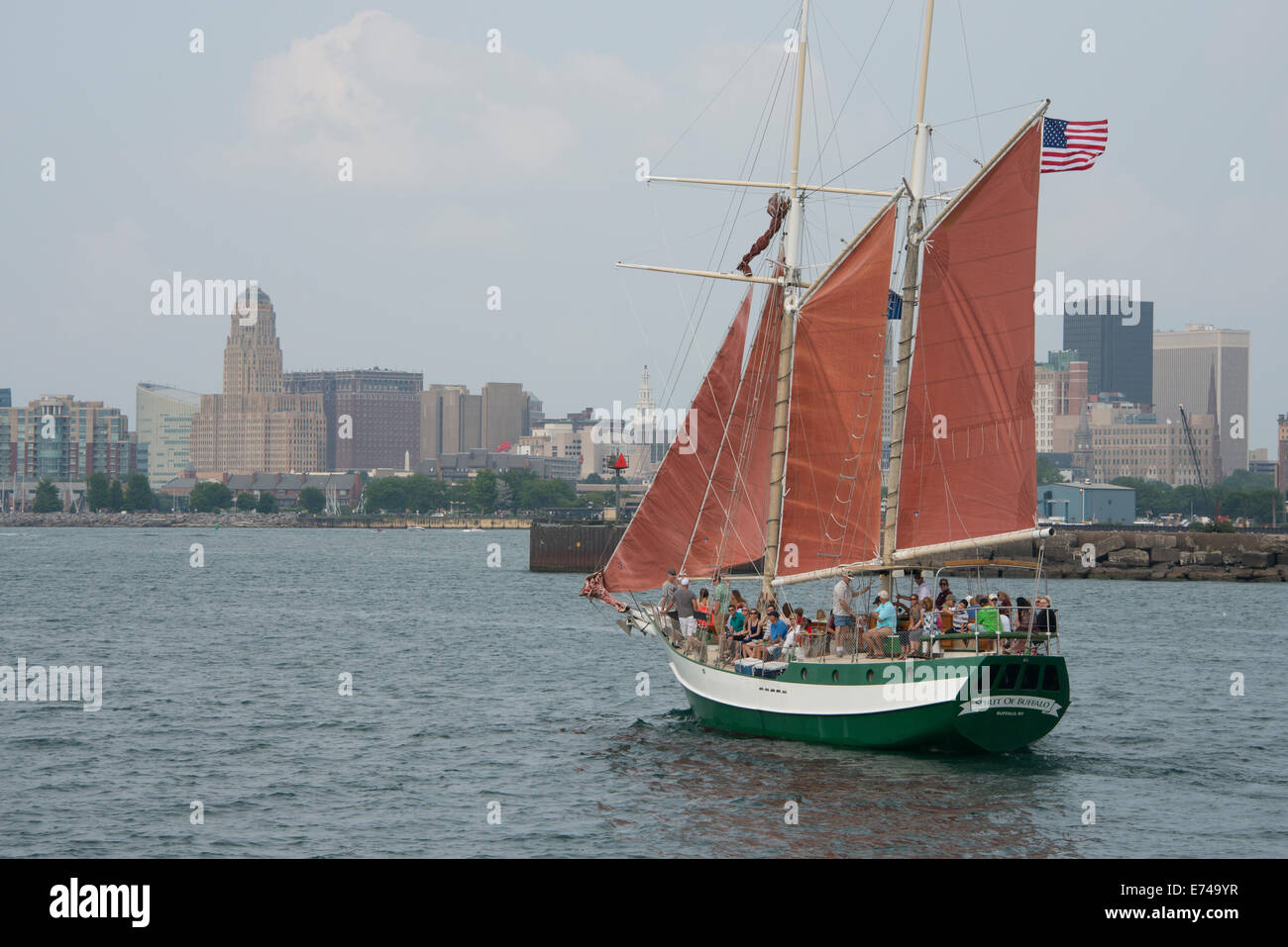 New York, Buffalo, il Lago Erie. Spirito di Buffalo, rosso-navigato classic 73 piedi topsail sight-seeing goletta. Lo skyline di Buffalo. Foto Stock