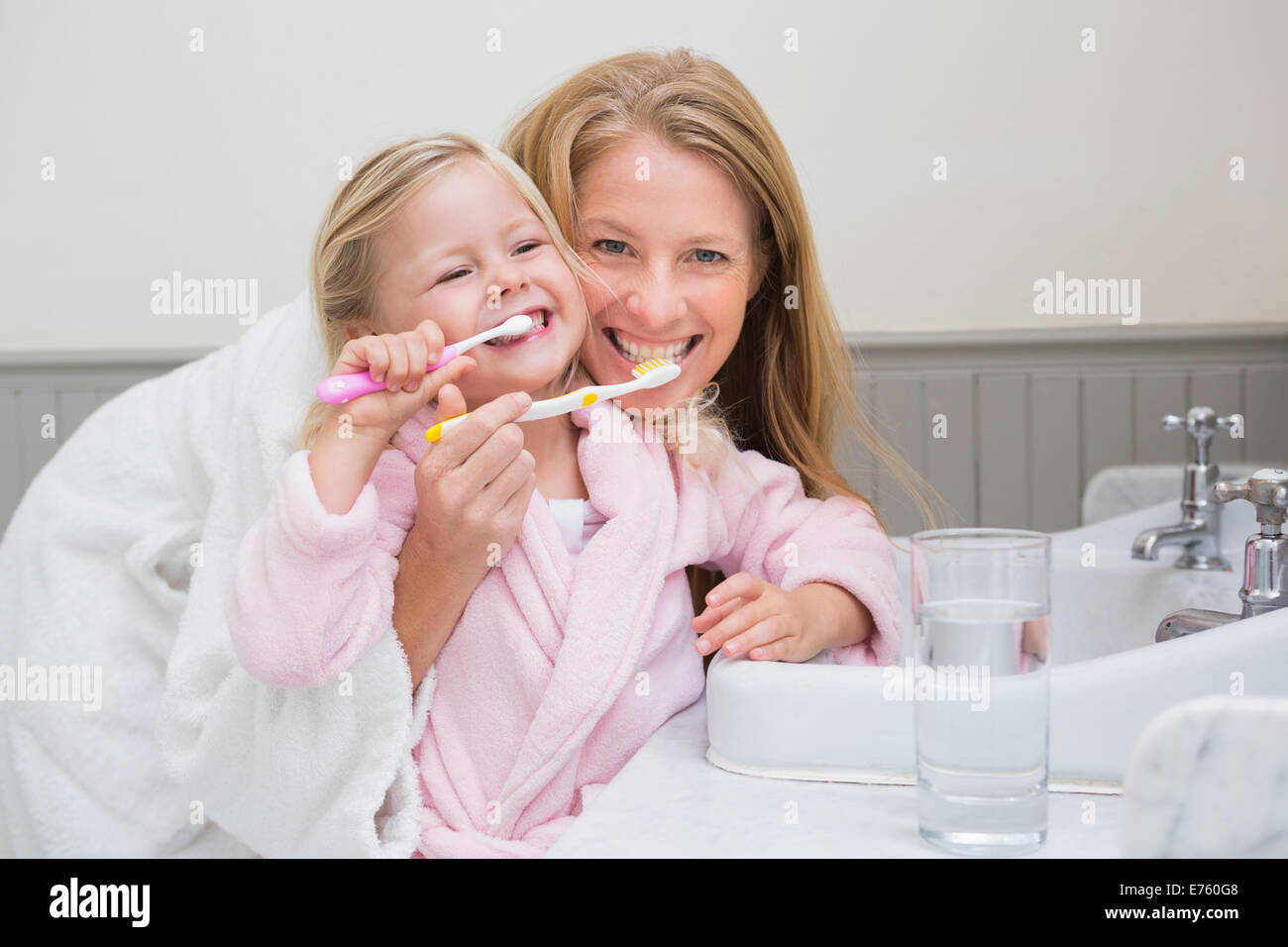Felice madre e figlia lavarsi i denti Foto Stock