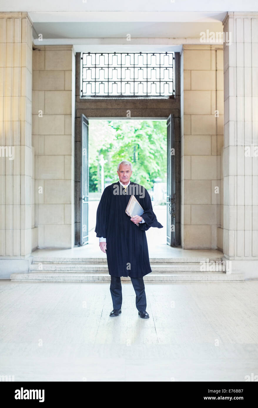 Giudice in piedi di fronte a porte a courthouse Foto Stock