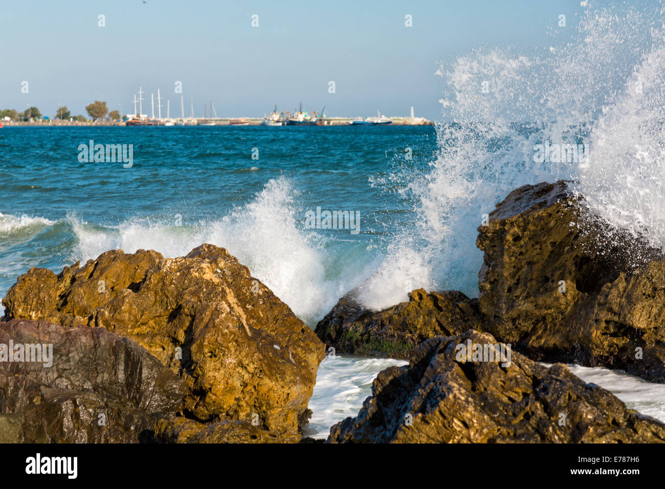 Mare, grande onda e schizzi su pietre in riva al mare Foto Stock