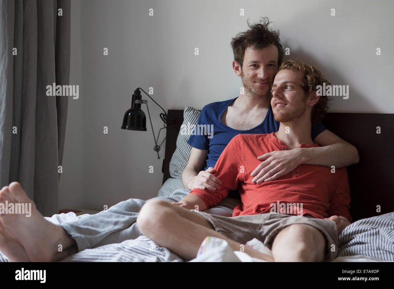 Amorevole coppia gay relax nel letto di casa Foto Stock