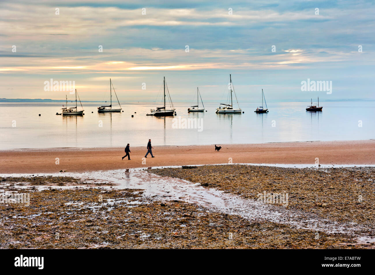 La mattina presto sulla spiaggia di Brodrick, Isle of Arran, Scozia, con cane walkers. Foto Stock