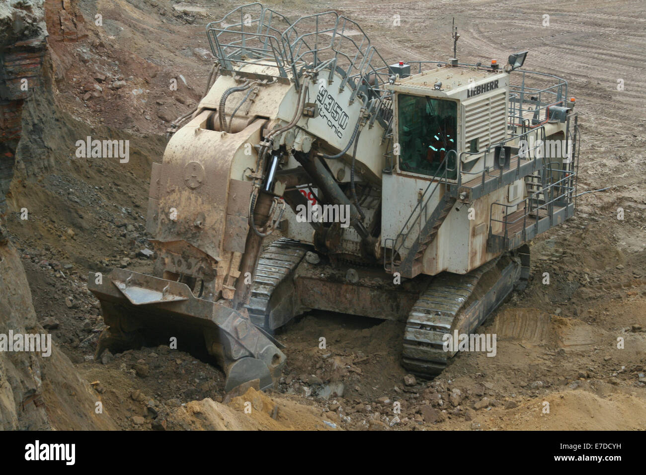 Un massiccio faccia Liebherr pala carichi di escavatore sovraccaricare il suolo in una grande apertura Africani in ghisa miniera di rame. Foto Stock