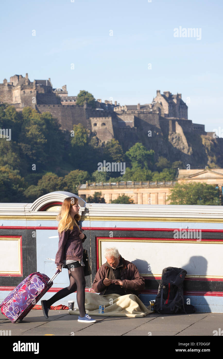 Senzatetto di accattonaggio sul North Bridge, con il Castello di Edimburgo in background, Edimburgo, Scozia, Regno Unito Foto Stock