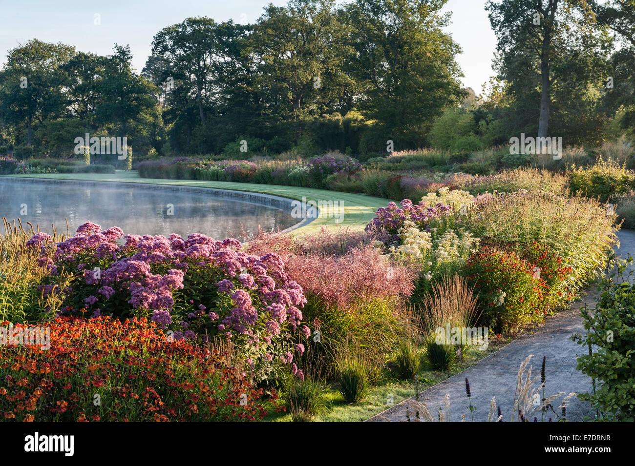 Il Royal Horticultural Society (RHS) giardini, Wisley, Surrey, Regno Unito. I bordi attorno al lago di sunrise nel mese di settembre Foto Stock