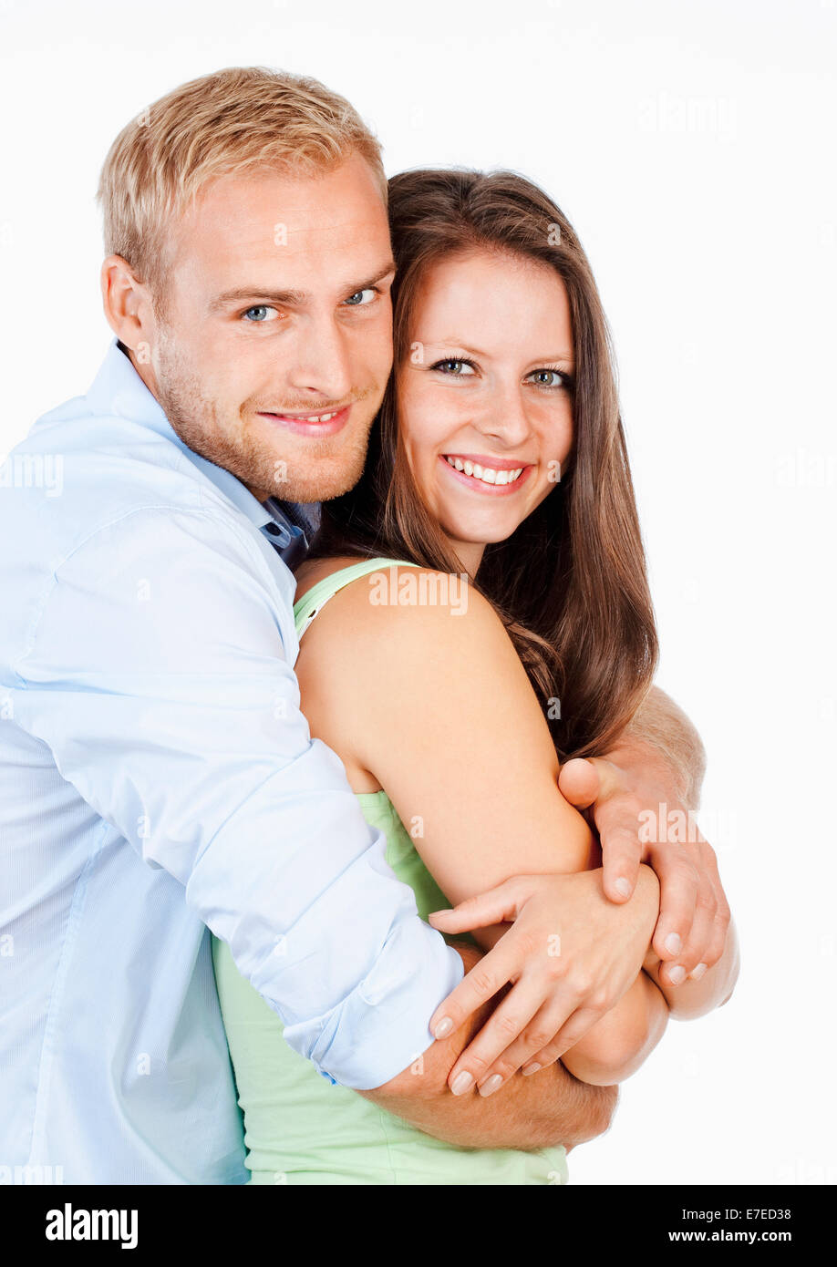 Ritratto di una felice coppia giovane sorridente cercando - Isolato su bianco Foto Stock