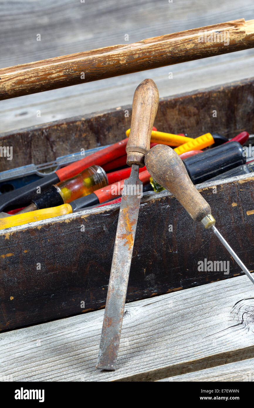 L'immagine verticale del vecchio strumento scatola riempita con strumenti su rustiche tavole in legno Foto Stock