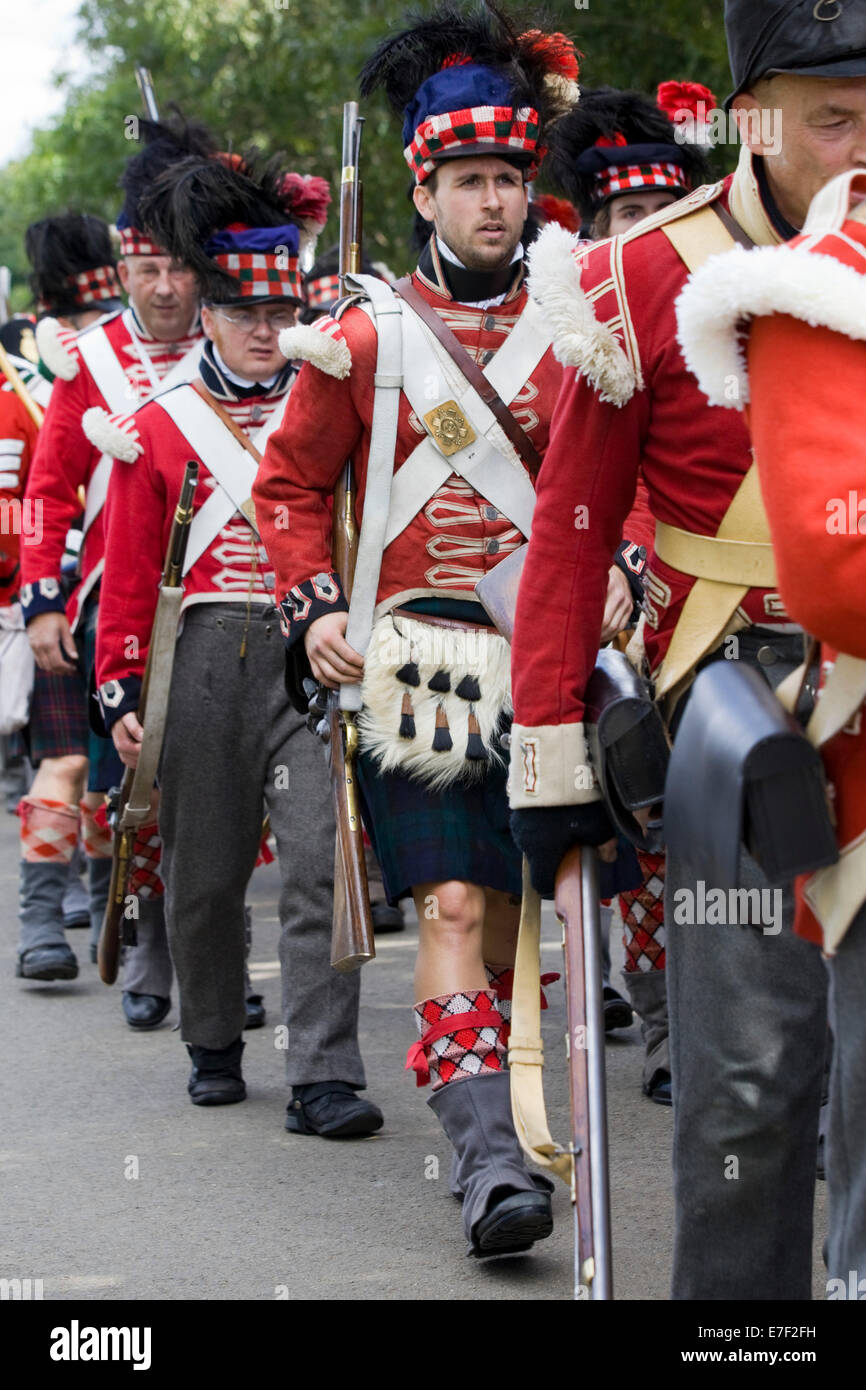 Rievocazione storica della XXXIII del reggimento di soldati a piedi in kilts andando in battaglia Foto Stock