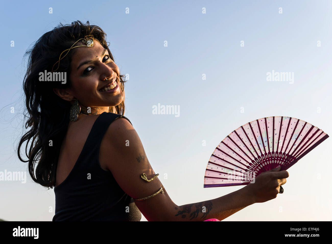 Sorridente donna indiana con un ventilatore, Goa, India Foto Stock