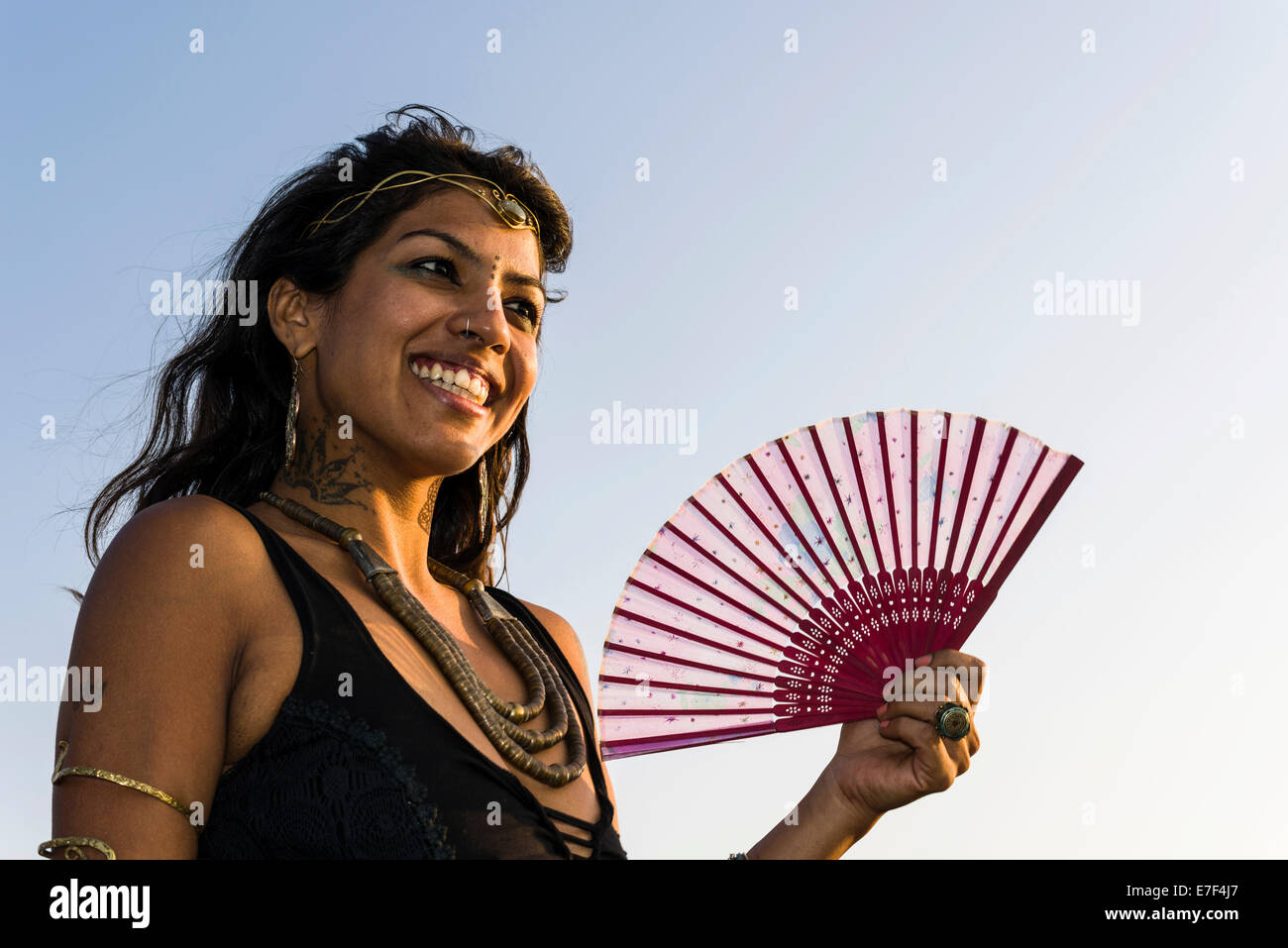 Sorridente donna indiana con un ventilatore, Goa, India Foto Stock