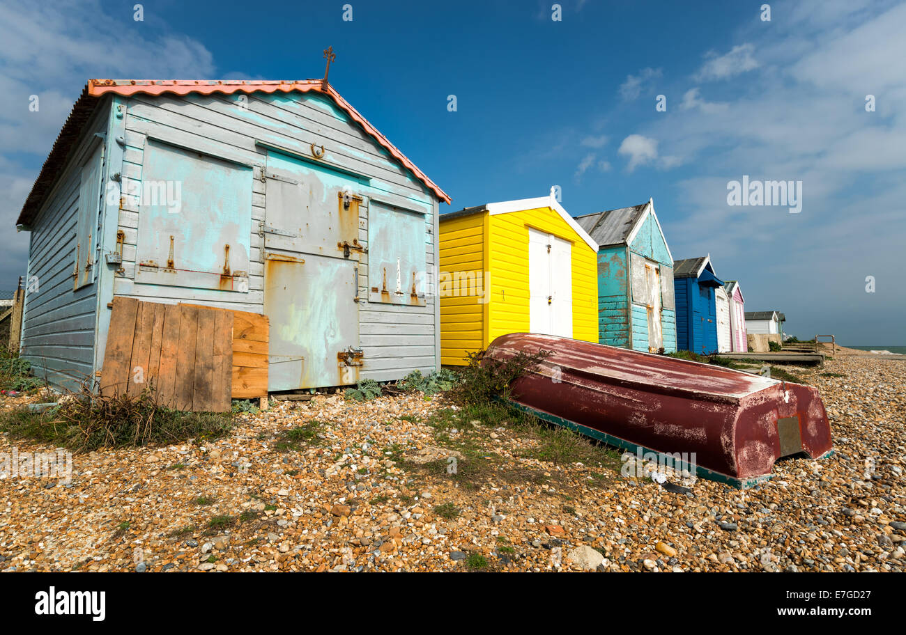 Una fila di pittoresca spiaggia di capanne su una spiaggia di ciottoli a St Leonards on Sea in Hastings, East Sussex Foto Stock