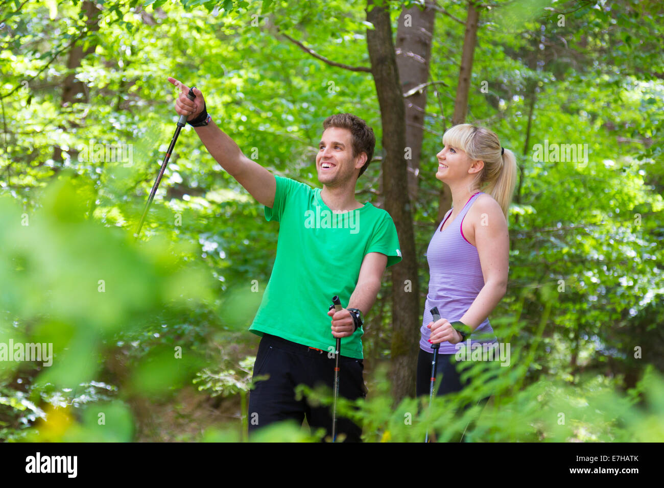 Giovani attivi sportivo giovane con bastoni per escursioni a piedi nella natura. Uno stile di vita attivo. Attività e svaghi all'esterno. Foto Stock