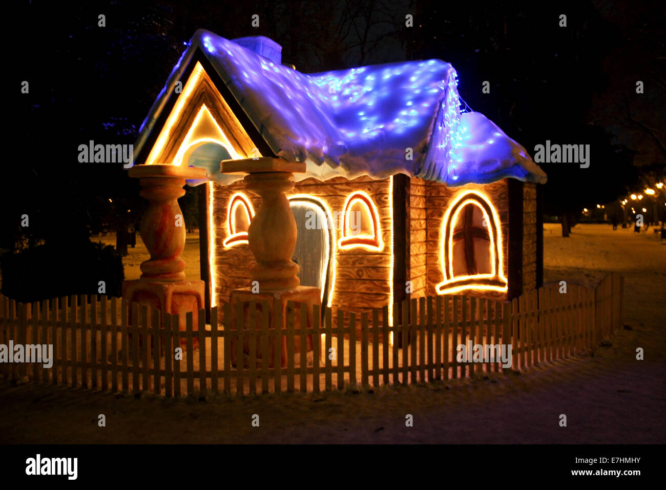 Una piccola casa illuminata di notte in inverno Foto Stock