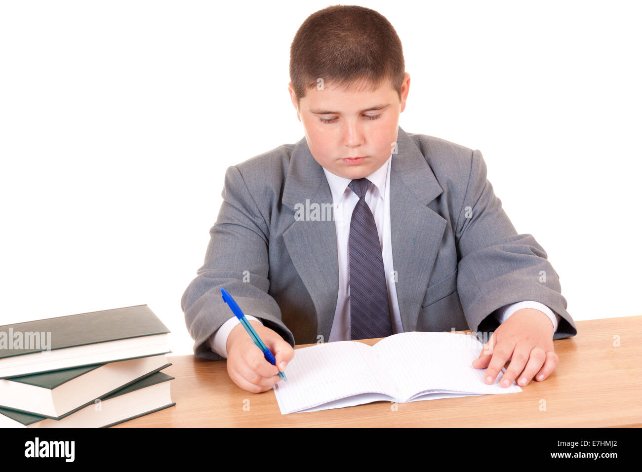 Un bambino prevede compiti su sfondo bianco Foto Stock
