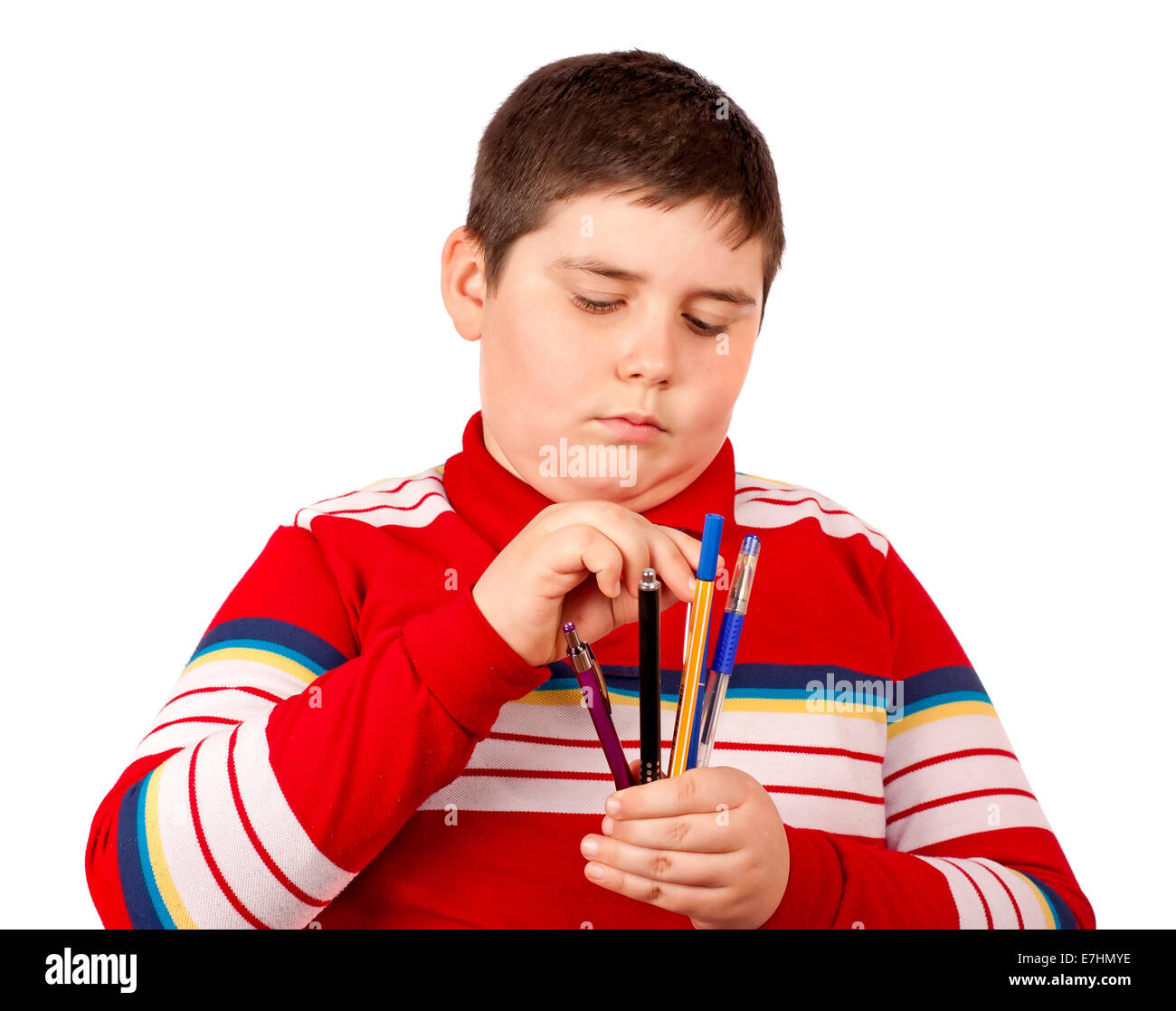 Il bambino che non sa quello che fa la penna per scegliere, isolato su sfondo bianco Foto Stock