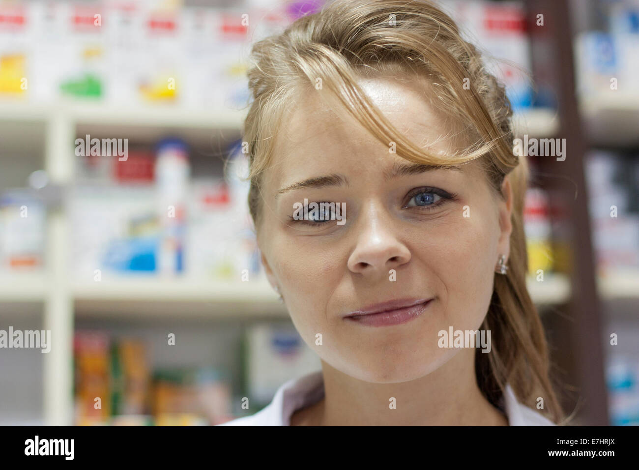 Il farmacista donna sorridente e guardando la fotocamera Foto Stock