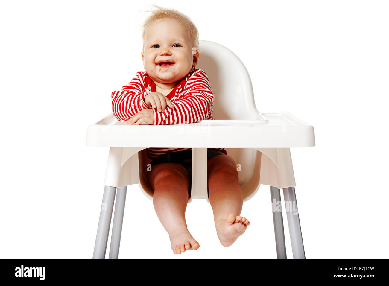 Ritratto di bambino con bocca sporca dopo aver mangiato. Baby seduti su una sedia. Foto Stock