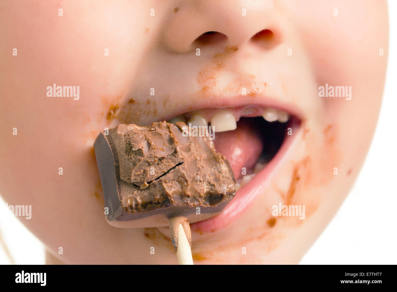 Il bambino mangiare il cioccolato lecca-lecca Foto Stock