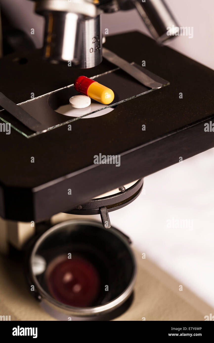 Laboratorio di Scienze sicuro di ricerca di nuovi farmaci, microscopio e pillole Foto Stock