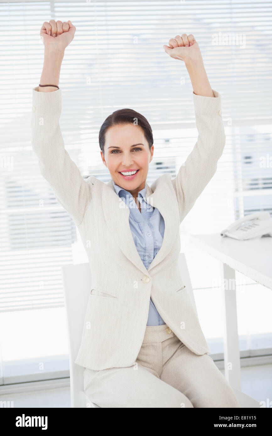 Sorridente imprenditrice celebrare durante il lavoro Foto Stock