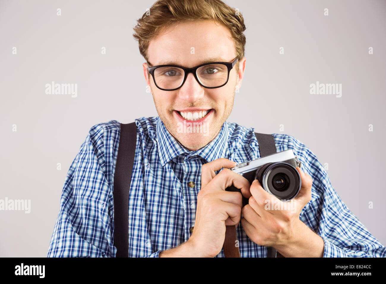 Geeky hipster tenendo una fotocamera retrò Foto Stock