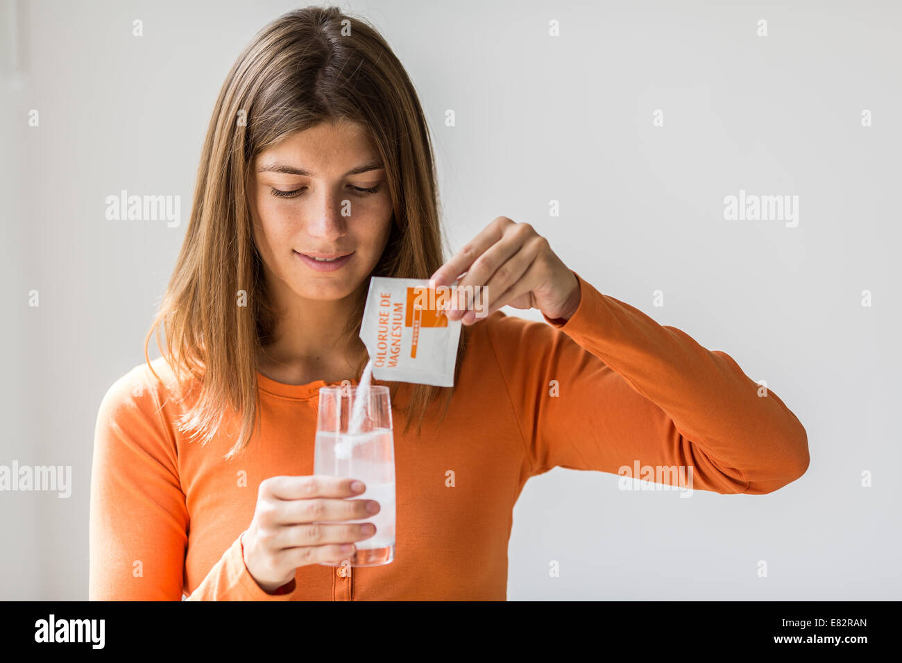 Donna prendendo il cloruro di magnesio. Foto Stock