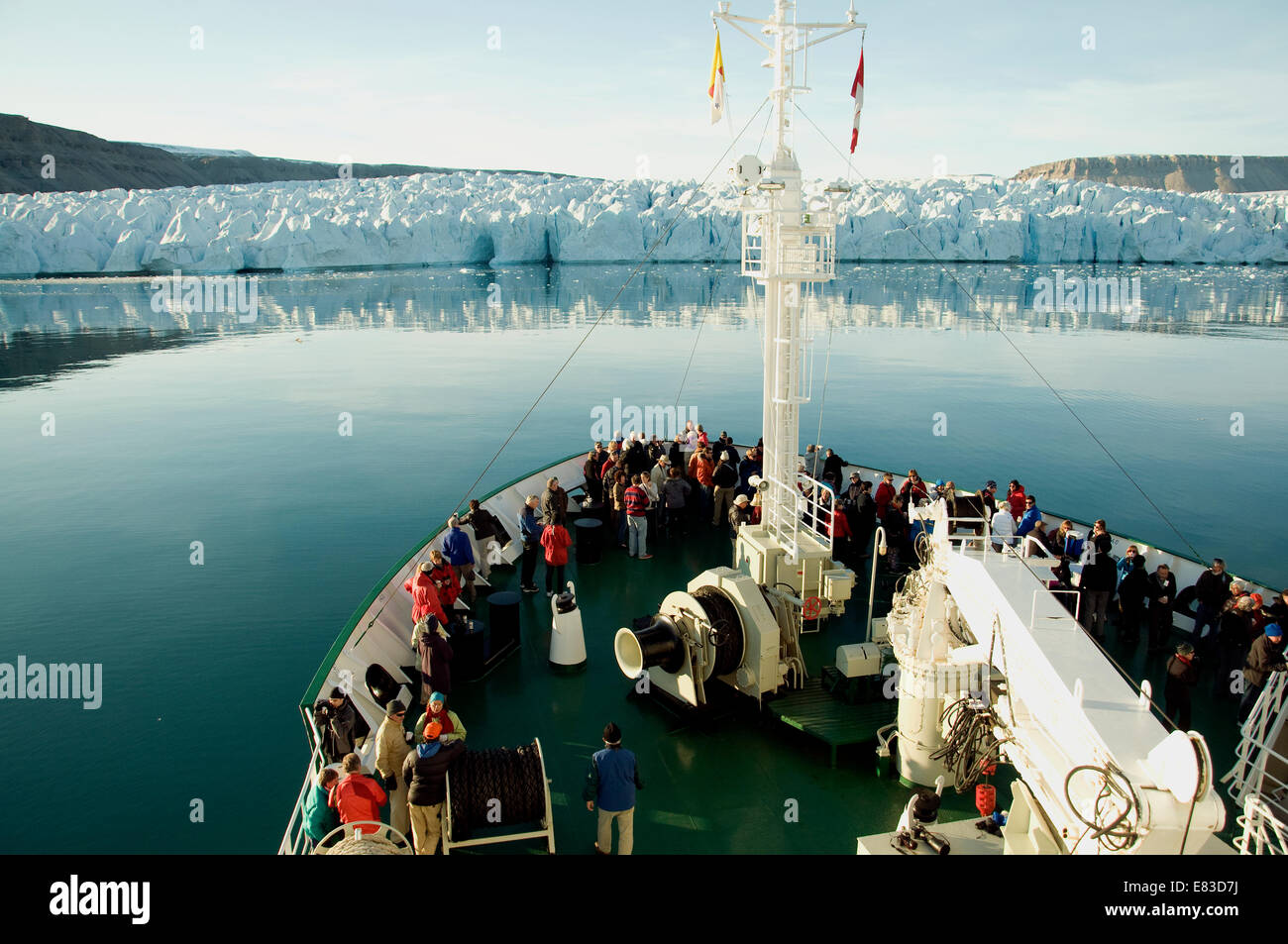 Passeggeri a bordo del Akademik Ioffe, una ricerca polare nave, ammirare una spettacolare parete di ghiaccio in Artico Canadese Foto Stock