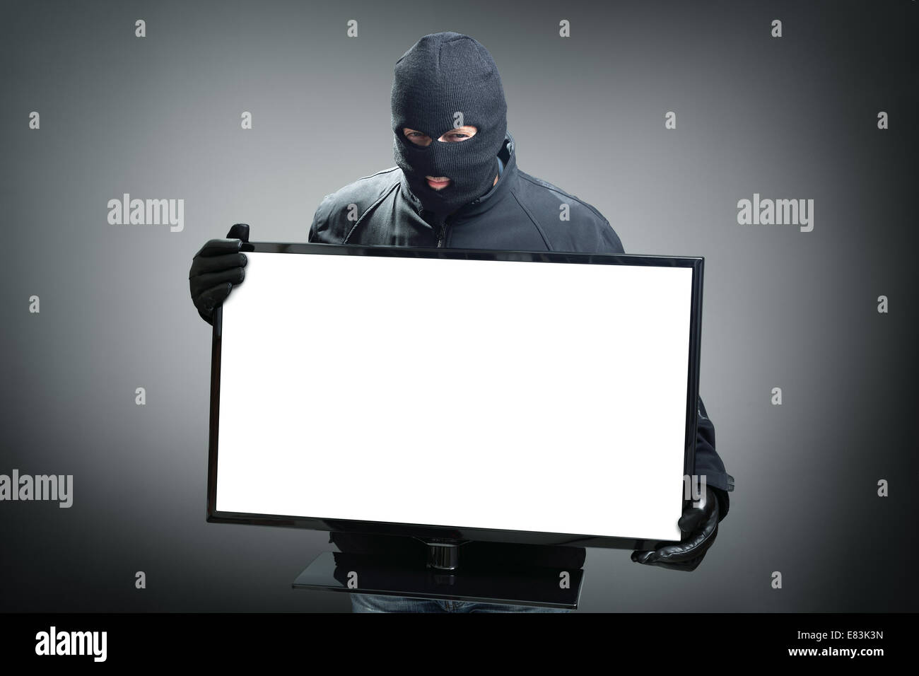 Ladro rubare il monitor di un computer Foto Stock